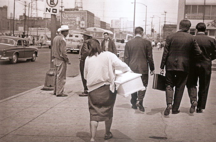 Mexico City, a needy woman carrying an empty coffin,  which will contain the body of her daughter